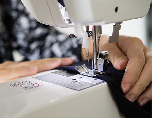 hands sewing at a machine